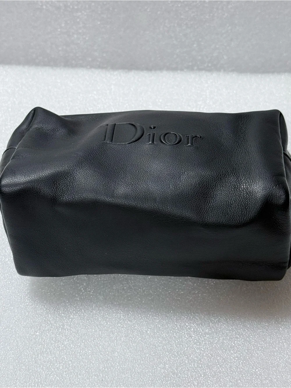 Dior makeup bag features a black exterior
